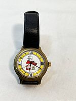 Front view of the Boctok wristwatch featuring Pope John Paul II on the dial with Roman numeral markings and black leather strap.