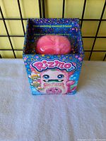 Front view of Rizmo toy in original box showing the pink fuzzy character and colorful packaging details