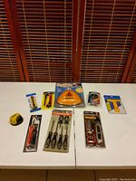 Full view of all tools laid on white table against wooden blinds