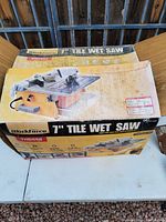 Closed original box for Workforce 7" Tile Wet Saw showing the product image and branding