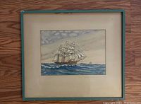 Front view of framed watercolor painting of sailing ship on ocean with cloudy sky, signed AA7.