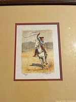 Front view of the framed lithograph showing the cowboy on a horse with lasso, signature, and edition number visible.