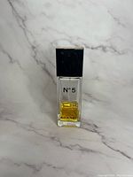 Front view of vintage Chanel Nº 5 perfume bottle showing label and cap