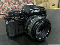 Front angle showing Minolta X-700 camera body with attached 50mm 1:1.7 lens.