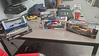 Overview of all five sealed model car packages displayed on table