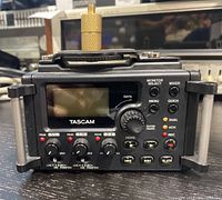 Front view of Tascam DR-60D with display, knobs, and control buttons.