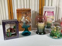 Lot of candle holders, musical water ball, and Santa night light all in original boxes