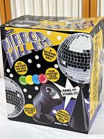 Photo of unopened original box packaging for Lite F/X Mirror Ball Kit showing product graphics, features of rotating mirror ball, light, hanger stand, and colored filters.