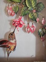 Close-up of framed decoupage shadow art showing hummingbird and pink fuchsia flowers.