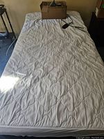 Top view of assembled bed with mattress and power adapter on top