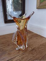 Front/side view of the amber chalet glass vase showing its twisted form and amber coloring.
