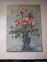 Full view of the watercolor painting depicting pink roses in a glass vase on a table, with a soft blue and green background.