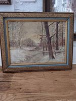 Full frontal photo of vintage oil painting in ornate carved wood frame.