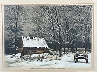 Framed black and white winter scene print shows a snow-covered rustic log shanty, bare trees, a person working outside, and a wooden cart.