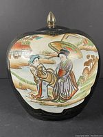 Front view of ginger jar showing painted scene of two women with parasol