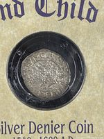 Close-up front view of the silver denier coin inside a black circular capsule, showing details of the coin's design and inscriptions.
