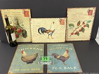 Photo showing all five vintage metal signs: two chicken coupe signs and three French postcard style fruit/chicken signs