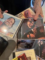 Close-up image showing several CDs including Bonnie Raitt, Willie Nelson, and Paul Simon.