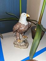 Side view of ceramic bald eagle statue showing detail and colors