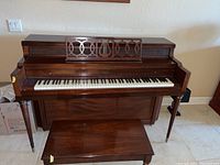 Front elevation of Everett upright piano and bench
