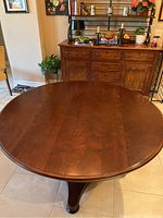 Top view of the round wooden dining table showing wood grain and finish.