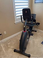 Black Schwinn exercise bike with ergonomic seat and backrest, placed indoors.