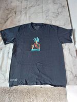 Full view of black Dragon Ball Super child medium T-shirt with printed character graphic and logo.