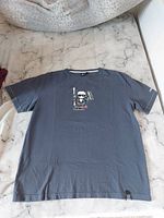Full view of a dark blue child XL T-shirt with printed cartoon character on front.