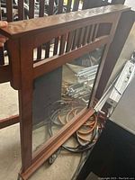 Front view of the wood framed mirror showing the reflective surface and decorative frame details.