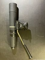 Full view of the Bausch & Lomb Discoverer Zoom mountable scope showing the zoom tube, adjustment knob, and mount handle.