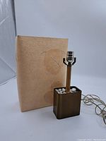 Full view of vintage lamp with beige leaf-patterned lampshade, brass-tone base with white stones, and attached power cord.