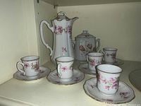 Fine porcelain hot chocolate set with chocolate pot, holder, 5 cups and saucers, all decorated with pink floral pattern