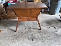 Front view with lid closed showing box shape and splayed legs