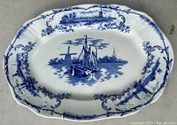 Top view showing the blue and white design with sailboat, windmills, and floral border.