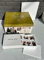 Gift set packaging showing Department 56 gold and cream box labeled ‘Chancery Corner Dickens Village Gift Set’