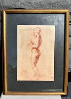 Front view of framed sepia nude print with dark green matte and gold frame.