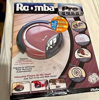 Retail packaging box front with Roomba Pro Elite branding and vacuum image