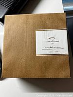 Box packaging of brand new Pottery Barn Alana frame in coffee color for 5x5 inch photos.