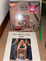 Stack of vinyl LP albums including 'Memories of Germany' by Hamburg Philharmonic Pops Orchestra and 'Moving' by Peter, Paul and Mary