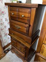 Photo showing two matching wood bedside tables stacked, each with two drawers and varied drawer pulls.