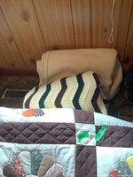 Showing part of the crocheted afghan and Dresden plate quilt with detailed patchwork and stitching pattern