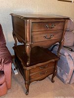 Pair of stacked wood end tables showing curved legs, drawers with ornate metal handles, and the overall finish.