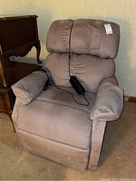 Full view of the Golden upholstered lift recliner chair showing overall shape, armrests, and attached remote.