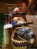 Two wooden folding knitting bags filled with yarn skeins and knitting needles seen from above and side angles.