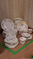 Full set of Paragon Victoriana Rose china arranged showing all components including plates stacked and cups near front.