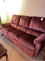 Full front and top view of brown reclining three-seater sofa, showing seat cushions, armrests and back cushions, no visible wear.