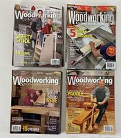 Four magazine covers showing various woodworking projects such as a safety stool, mitre gauges, paddle design, and a small shop issue.