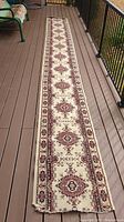 Full view of the carpet runner on a deck showing overall condition and length.