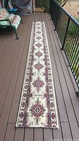 Full view of the entire carpet runner laid out showing length and pattern.