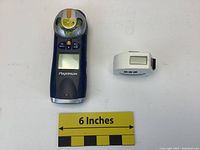 Mastercraft Maximum laser level next to Starrett Digitape digital measuring tape with 6 inch scale for size reference.